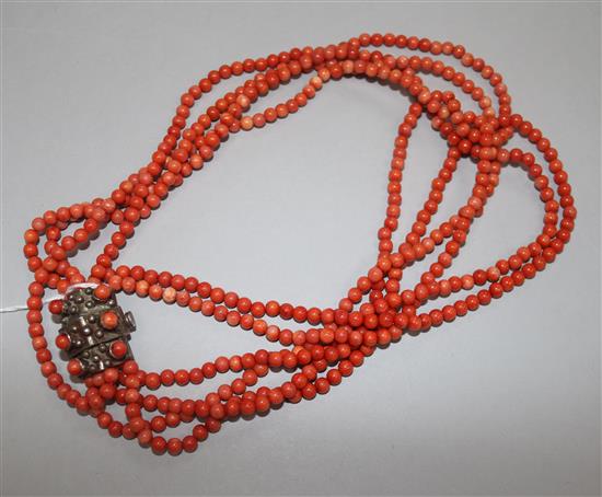 A five strand coral bead necklace with white metal and coral bead set clasp, 44cm.